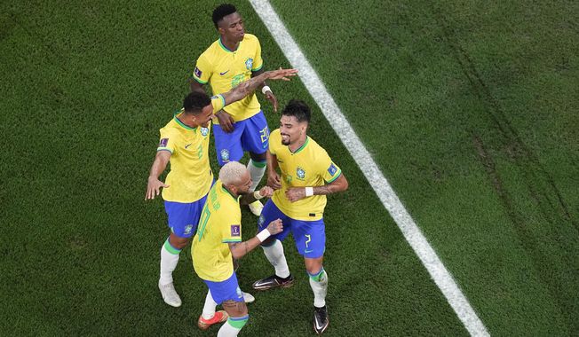 Brazil&#x27;s Vinicius Junior, Danilo and Neymar dance with Lucas Paqueta, right, after he scored his side&#x27;s fourth goal during the World Cup round of 16 soccer match between Brazil and South Korea, at the Stadium 974 in Al Rayyan, Qatar, Monday, Dec. 5, 2022. (AP Photo/Pavel Golovkin)