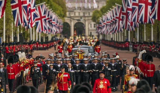 The coffin of Queen Elizabeth II is pulled past Buckingham Palace following her funeral service in Westminster Abbey in central London, Monday, Sept. 19, 2022. In June, Britain celebrated Queen Elizabeth II’s Platinum Jubilee — 70 years on the throne — with parties, pageants and a service of thanksgiving. Three months later, the queen died, aged 96, at Balmoral Castle in Scotland. (AP Photo/Vadim Ghirda, Pool)