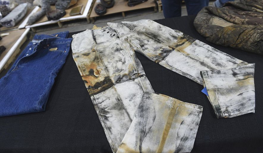 A pair of work pants, possibly made by or for Levi Strauss, from the S.S. Central America are seen in a warehouse in Sparks, Nev., on May 4, 2022. Pulled from a sunken trunk at an 1857 shipwreck off the coast of North Carolina, work pants that auction officials describe as the oldest known pair of jeans in the world have sold for $114,000.  (Jason Bean/The Reno Gazette-Journal via AP, File)