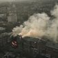 An apartment burns after Russian shelling in Bakhmut, Donetsk region, Ukraine, Wednesday, Dec. 7, 2022. (AP Photo/LIBKOS)