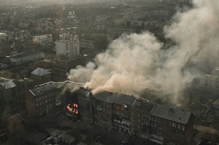 An apartment burns after Russian shelling in Bakhmut, Donetsk region, Ukraine, Wednesday, Dec. 7, 2022. (AP Photo/LIBKOS)