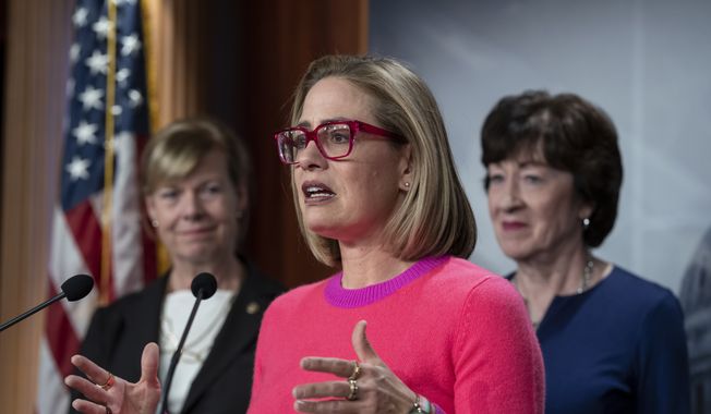 Sen. Kyrsten Sinema, D-Ariz., flanked by Sen. Tammy Baldwin, D-Wis., left, and Sen. Susan Collins, R-Maine, speak to reporters following Senate passage of the Respect for Marriage Act, at the Capitol in Washington, Tuesday, Nov. 29, 2022. Sen. Sinema announced on Friday, Dec. 9, 2022, that she has left the Democratic Party and registered as an independent. (AP Photo/J. Scott Applewhite, File)