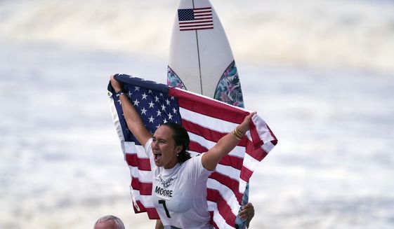 Carissa Moore, of the United States, celebrates winning the gold medal of the women&#39;s surfing competition at the 2020 Summer Olympics, July 27, 2021, at Tsurigasaki beach in Ichinomiya, Japan. Moore won the AAU James E. Sullivan Award as the nation’s most outstanding college or Olympic athlete. Moore is the first surfer and first native Hawaiian to win the 92nd annual award. She was presented the trophy on Thursday in Honolulu. (AP Photo/Francisco Seco, File)
