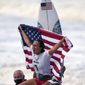 Carissa Moore, of the United States, celebrates winning the gold medal of the women&#39;s surfing competition at the 2020 Summer Olympics, July 27, 2021, at Tsurigasaki beach in Ichinomiya, Japan. Moore won the AAU James E. Sullivan Award as the nation’s most outstanding college or Olympic athlete. Moore is the first surfer and first native Hawaiian to win the 92nd annual award. She was presented the trophy on Thursday in Honolulu. (AP Photo/Francisco Seco, File)