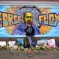 Damarra Atkins pays respect to George Floyd at a mural at George Floyd Square in Minneapolis, April 23, 2021. Minneapolis will buy the boarded-up Speedway gas station at George Floyd Square, the City Council decided unanimously on Thursday, Dec. 8, 2022. The area has become a protest site since Floyd, a Black man, was killed there by a white police officer in May 2020, sparking a national reckoning on racial injustice. (AP Photo/Julio Cortez, File)