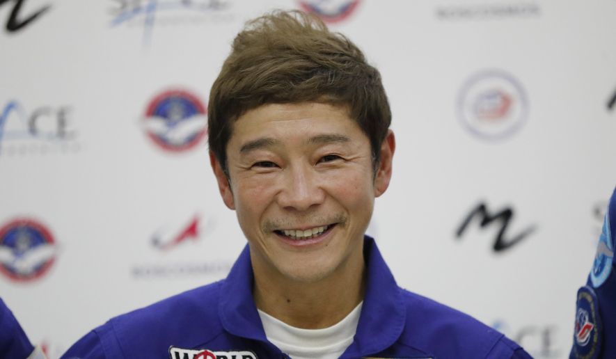 Space flight participant Yusaku Maezawa attends a news conference ahead of the expedition to the International Space Station at the Gagarin Cosmonauts&#x27; Training Center in Star City outside Moscow, Russia, on Oct. 14, 2021. Maezawa said Friday, Dec. 9, 2022 that K-pop star TOP will be among the eight crew members who will join him on a flyby around the moon on a SpaceX spaceship next year. (Shamil Zhumatov/Pool Photo via AP, File)