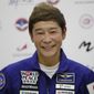 Space flight participant Yusaku Maezawa attends a news conference ahead of the expedition to the International Space Station at the Gagarin Cosmonauts&#39; Training Center in Star City outside Moscow, Russia, on Oct. 14, 2021. Maezawa said Friday, Dec. 9, 2022 that K-pop star TOP will be among the eight crew members who will join him on a flyby around the moon on a SpaceX spaceship next year. (Shamil Zhumatov/Pool Photo via AP, File)