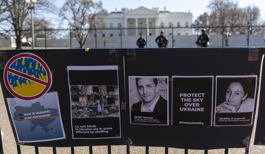 Signs and pictures of those killed, including journalist Brent Renaud, are displayed on a fence during a protest against Russia&#39;s invasion of Ukraine in Lafayette Park near the White House, Sunday, March 13, 2022, in Washington.  The International Federation of Journalists says 67 journalists and media staff have been killed around the world so far in 2022, up from 47 last year. (AP Photo/Alex Brandon, File)