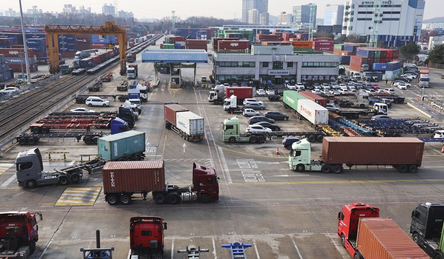 Container trucks run at the Inland Container Depot in Uiwang, a logistics hub, South Korea, Friday, Dec. 9, 2022. (Hong Ki-won/Yonhap via AP)