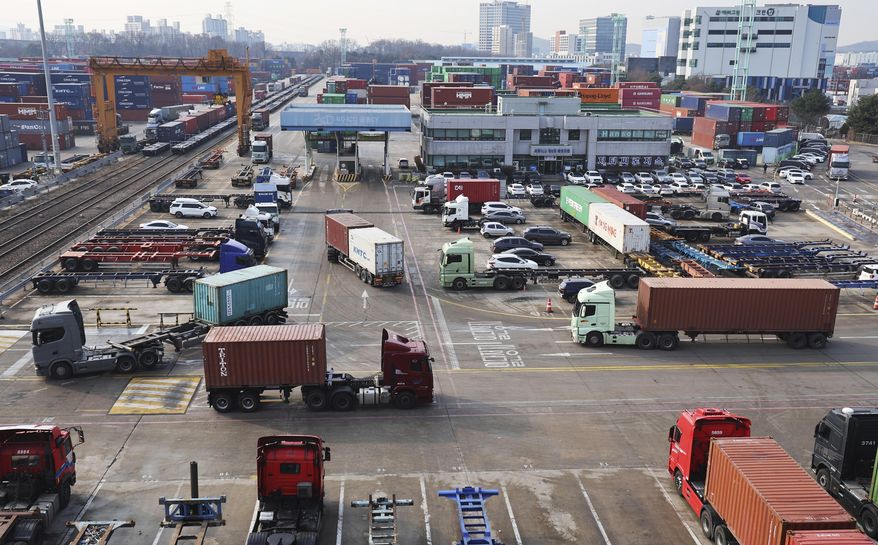 Container trucks run at the Inland Container Depot in Uiwang, a logistics hub, South Korea, Friday, Dec. 9, 2022. (Hong Ki-won/Yonhap via AP)