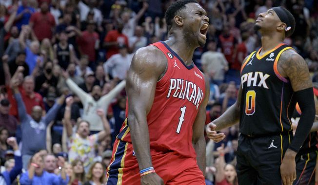 New Orleans Pelicans forward Zion Williamson (1) celebrates next to Phoenix Suns forward Torrey Craig (0) after dunking in the second half of an NBA basketball game in New Orleans, Friday, Dec. 9, 2022. (AP Photo/Matthew Hinton)