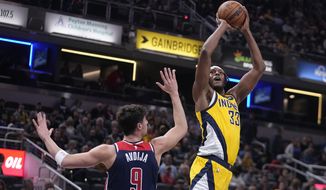 Indiana Pacers center Myles Turner (33) shoots over Washington Wizards forward Deni Avdija (9) during the first half of an NBA basketball game, Friday, Dec. 9, 2022, in Indianapolis. (AP Photo/Darron Cummings)