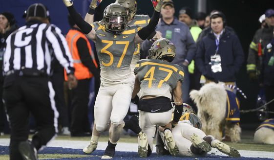 Army players celebrate after Army defensive back Noah Short (47) blocked a punt return by Navy punter Riley Riethman (90) for a touchdown in the second quarter of an NCAA college football game in Philadelphia, Saturday, Dec. 10, 2022. (Heather Khalifa/The Philadelphia Inquirer via AP)