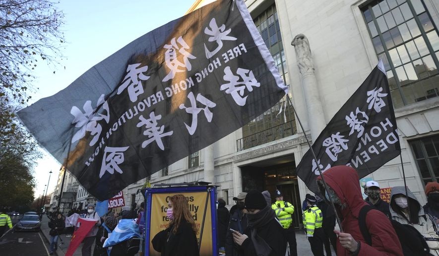 Protesters hold flags that reads "Hong Kong independent" as the protesters gather outside the China Embassy in London, Saturday, Dec. 10, 2022. Protesters demanded the democracy and rights for people in China. (AP Photo/Kin Cheung)