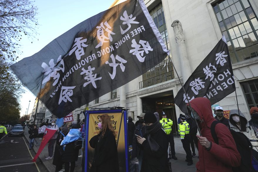 Protesters hold flags that reads "Hong Kong independent" as the protesters gather outside the China Embassy in London, Saturday, Dec. 10, 2022. Protesters demanded the democracy and rights for people in China. (AP Photo/Kin Cheung)