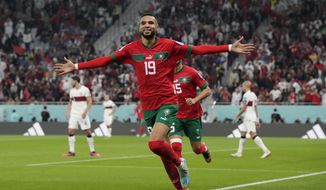 Morocco&#39;s Youssef En-Nesyri celebrates after scoring his side&#39;s first goal during the World Cup quarterfinal soccer match between Morocco and Portugal, at Al Thumama Stadium in Doha, Qatar, Saturday, Dec. 10, 2022. (AP Photo/Martin Meissner)