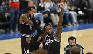 Los Angeles Clippers guard John Wall (11) acknowledges the crowd during the first quarter of the team&#39;s NBA basketball game against the Washington Wizards, Saturday, Dec. 10, 2022, in Washington. (AP Photo/Terrance Williams)