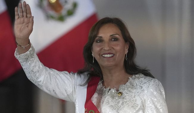 Peru&#x27;s President Dina Boluarte waves as she arrives to swear in her cabinet members at the government palace in Lima, Peru, Saturday, Dec. 10, 2022.  (AP Photo/Guadalupe Pardo)