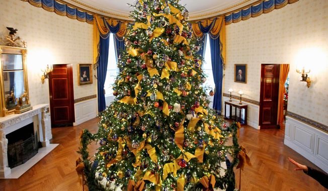 An 18-foot high Douglas fir adorns the Blue Room at the White House on Dec. 2, 2009. The first known Christmas tree at the White House was in the tenure of Benjamin Harrison. (Associated Press)