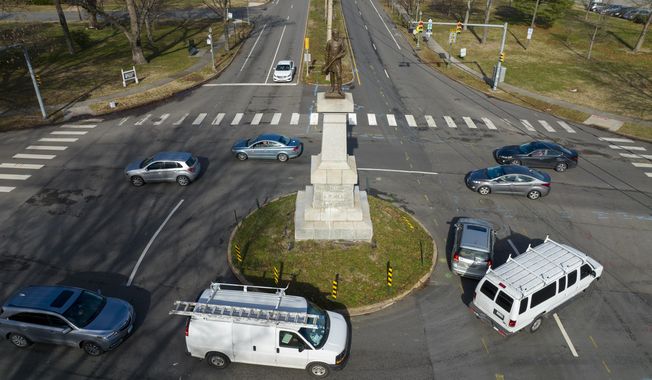 Traffic drives in the circle at the monument of confederate General A.P. Hill, which contains his remains, is in the middle of a traffic circle on Arthur Ashe Blvd. Jan. 6, 2022, in Richmond, Va. Work to relocate Richmond’s final city-owned Confederate monument should start this week after a judge refused a request to delay the removal of the statue of Gen. A.P. Hill from its prominent spot in Virginia&#x27;s capital, an official said. (AP Photo/Steve Helber, File)