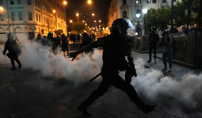 Tear gas is returned to police trying to break up supporters of ousted President Pedro Castillo at plaza San Martin in Lima, Peru, Sunday, Dec. 11, 2022. Peru&#x27;s Congress voted to remove Castillo from office Wednesday and replace him with the vice president, shortly after Castillo tried to dissolve the legislature ahead of a scheduled vote to remove him. (AP Photo/Martin Mejia)
