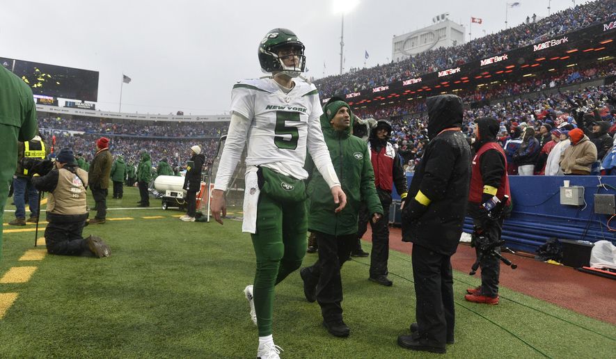 New York Jets quarterback Mike White (5) walks to the locker room during the second half of an NFL football game against the Buffalo Bills, Sunday, Dec. 11, 2022, in Orchard Park, N.Y. As a precaution, Jets head coach Robert Saleh said White was sent to the hospital after the game to be evaluated. (AP Photo/Adrian Kraus)