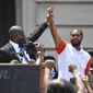 Attorney Benjamin Crump, left, holds up the hand of Kenneth Walker during a rally on the steps of the Kentucky State Capitol in Frankfort, Ky., on June 25, 2020. Walker, the boyfriend of Breonna Taylor who fired a shot at police as they burst through Taylor&#x27;s door the night she was killed, has settled two lawsuits against the city of Louisville, his attorneys said Monday, Dec. 12, 2022. (AP Photo/Timothy D. Easley, File)