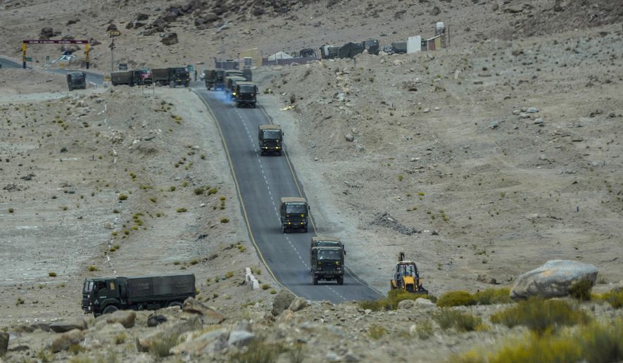 Indian army vehicles move in a convoy in the cold desert region of Ladakh, India, Tuesday, Sept. 20, 2022. Nestled between India, Pakistan and China, Ladakh has not just faced territorial disputes but also stark climate change. (AP Photo/Mukhtar Khan)