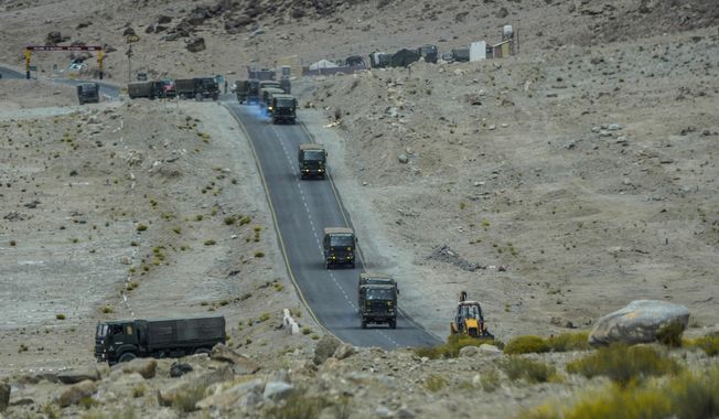 Indian army vehicles move in a convoy in the cold desert region of Ladakh, India, Tuesday, Sept. 20, 2022. Nestled between India, Pakistan and China, Ladakh has not just faced territorial disputes but also stark climate change. (AP Photo/Mukhtar Khan)