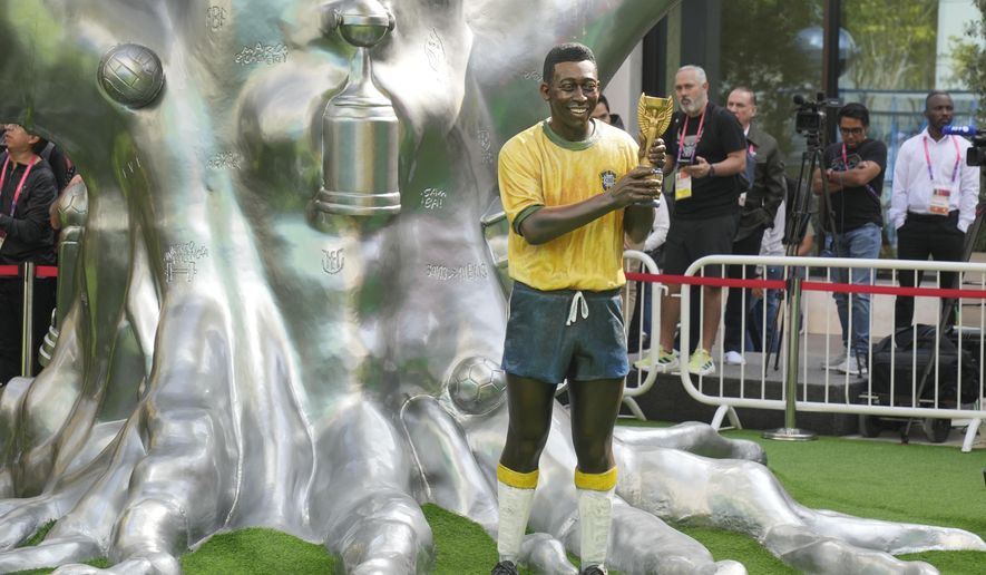 A life-size statue of Brazilian soccer legend Pele is displayed during an Conmebol event to pay tribute to Pele in Doha, Qatar, Sunday, Dec. 11, 2022. (AP Photo/Andre Penner)