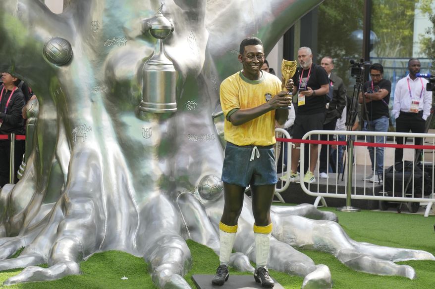 A life-size statue of Brazilian soccer legend Pele is displayed during an Conmebol event to pay tribute to Pele in Doha, Qatar, Sunday, Dec. 11, 2022. (AP Photo/Andre Penner)