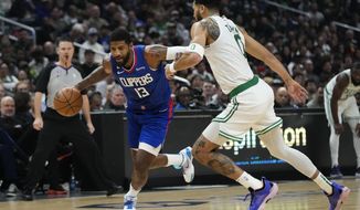 Los Angeles Clippers&#39; Paul George (13) drives toward the basket as he is pressured by Boston Celtics&#39; Jayson Tatum during first half of an NBA basketball game, Monday, Dec. 12, 2022, in Los Angeles. (AP Photo/Jae C. Hong)