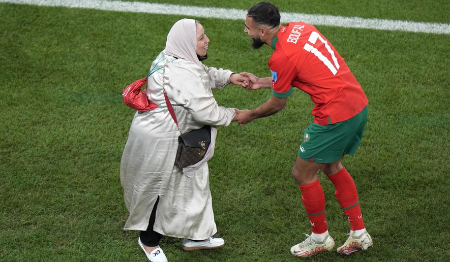 Morocco&#x27;s Sofiane Boufal, right, celebrates with his mother after his team&#x27;s win in the World Cup quarterfinal soccer match between Morocco and Portugal, at Al Thumama Stadium in Doha, Qatar, Saturday, Dec. 10, 2022. (AP Photo/Luca Bruno)
