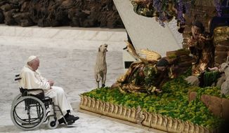 Pope Francis pauses in front of a nativity scene set up in Paul VI Hall at The Vatican at the end of his weekly general audience, Wednesday, Dec. 14, 2022. Pope Francis called Wednesday for a &quot;humble&quot; Christmas this year, with reduced spending on gifts and for the savings to be donated instead to help the &quot;suffering people of Ukraine.&quot; (AP Photo/Domenico Stinellis)