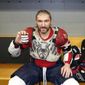 Washington Capitals&#39; Alex Ovechkin holds his 798, 799, and 800th career goal pucks in the locker room next to hats collected for his hat trick after an NHL hockey game against the Chicago Blackhawks Tuesday, Dec. 13, 2022, in Chicago. (AP Photo/Charles Rex Arbogast) **FILE**