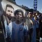A flag featuring Lionel Messi, left, and the late soccer great Diego Maradona hangs amid Argentina soccer fans after they watched the team&#39;s World Cup semifinal win over Croatia, hosted by Qatar, on a screen set up in the Palermo neighborhood of Buenos Aires, Argentina, Tuesday, Dec. 13, 2022. (AP Photo/Gustavo Garello)