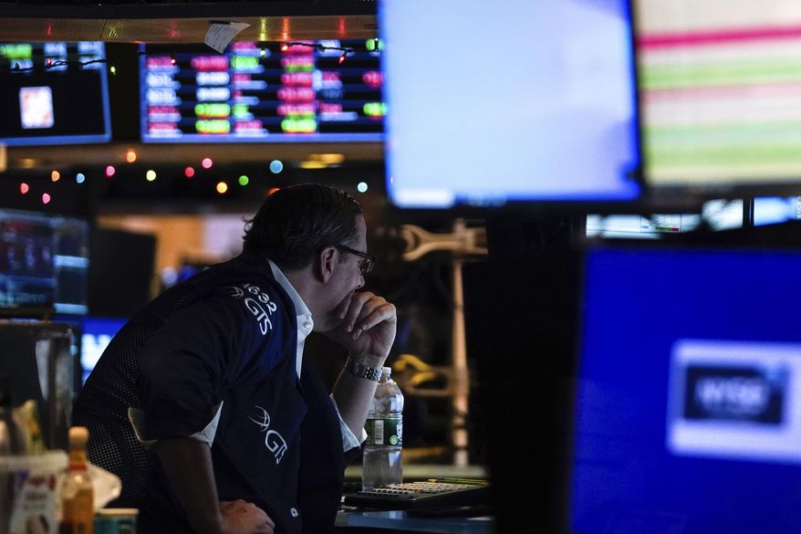 A trader works on the floor at the New York Stock Exchange, Wednesday, Dec. 14, 2022, in New York. (AP Photo/Julia Nikhinson)