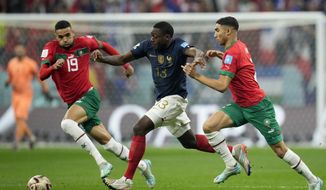 France&#39;s Youssouf Fofana, center, vies for the ball with Morocco&#39;s Youssef En-Nesyri and Achraf Hakimi, right, during the World Cup semifinal soccer match between France and Morocco at the Al Bayt Stadium in Al Khor, Qatar, Wednesday, Dec. 14, 2022. (AP Photo/Christophe Ena)