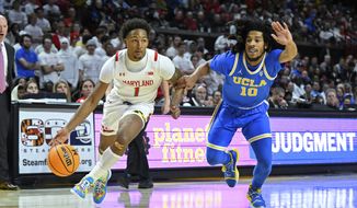 Maryland guard Jahmir Young (1) drives to the basket against UCLA guard Tyger Campbell (10) during the second half of an NCAA college basketball game, Wednesday, Dec. 14, 2022, in College Park, Md. (AP Photo/Terrance Williams)