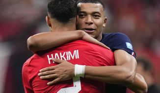 France&#x27;s Kylian Mbappe hugs Morocco&#x27;s Achraf Hakimi at the end of the World Cup semifinal soccer match between France and Morocco at the Al Bayt Stadium in Al Khor, Qatar, Wednesday, Dec. 14, 2022. France won 2-0 and will play Argentina in Sunday&#x27;s final. (AP Photo/Manu Fernandez)