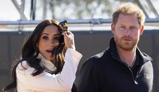 Prince Harry and Meghan Markle, Duke and Duchess of Sussex, visit the track and field event at the Invictus Games in The Hague, Netherlands, Sunday, April 17, 2022. (AP Photo/Peter Dejong, File)