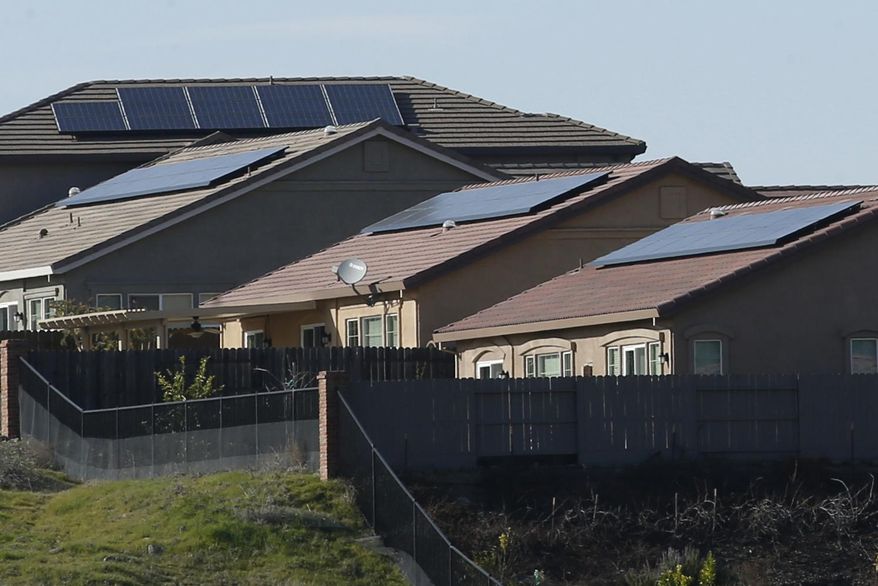 Solar panels on rooftops of a housing development in Folsom, Calif., are shown here on Feb. 12, 2020. California utility regulators will consider a proposal on Thursday, Dec. 15, 2022, to remake financial incentives for people who install rooftop solar panels on their homes. (AP Photo/Rich Pedroncelli) **FILE**