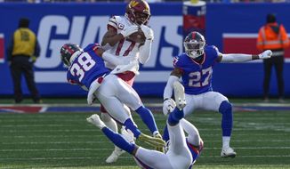 Washington Commanders&#39; Terry McLaurin, top, makes a catch during the first half of an NFL football game against the New York Giants, Sunday, Dec. 4, 2022, in East Rutherford, N.J. (AP Photo/John Minchillo)