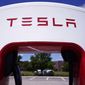Tesla Supercharger is seen at Willow Festival shopping plaza parking lot Wednesday, Aug. 10, 2022, in Northbrook, Ill. Shares of Tesla are sliding before the market open on Thursday, Dec. 15, 2022, after news broke that CEO Elon Musk sold another $3.58 billion worth of the electric vehicle maker’s stock this week.  (AP Photo/Nam Y. Huh, File)