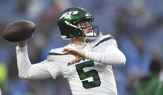New York Jets quarterback Mike White winds up to pass while warming up prior to an NFL football game against the Buffalo Bills, Sunday, Dec. 11, 2022, in Orchard Park, N.Y. (AP Photo/Adrian Kraus)