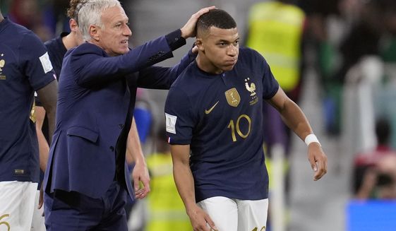 France&#x27;s head coach Didier Deschamps, left, celebrates a goal by France&#x27;s Kylian Mbappe, right, during the World Cup round of 16 soccer match between France and Poland, at the Al Thumama Stadium in Doha, Qatar, Sunday, Dec. 4, 2022. (AP Photo/Natacha Pisarenko)