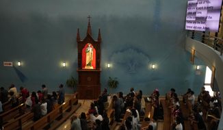People take part in a liturgy at the Catholic Church, Our Lady of the Rosary, at the Religious complex, in Doha, Qatar, Friday, Dec. 9, 2022. (AP Photo/Thanassis Stavrakis)