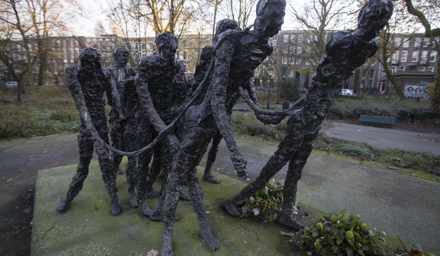 FILE - The National Monument Slavery Past by Erwin de Vries in  Amsterdam, Netherlands is seen in this Dec. 10, 2020 file photo. The Netherlands is expected to issue a national apology for its brutal slavery past when Dutch officials visit their former Caribbean colonies in late Dec. 2022. (AP Photo/Peter Dejong, File)