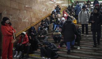 People rest in the subway station, being used as a bomb shelter during a rocket attack in Kyiv, Ukraine, Friday, Dec. 16, 2022. Ukrainian authorities reported explosions in at least three cities Friday, saying Russia has launched a major missile attack on energy facilities and infrastructure. Kyiv Mayor Vitali Klitschko reported explosions in at least four districts, urging residents to go to shelters. (AP Photo/Efrem Lukatsky)