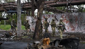 Russian troops walk in a destroyed part of the Illich Iron &amp;amp; Steel Works Metallurgical Plant in Mariupol, in territory under the government of the Donetsk People&#39;s Republic, eastern Ukraine, Wednesday, May 18, 2022. (AP Photo, File)